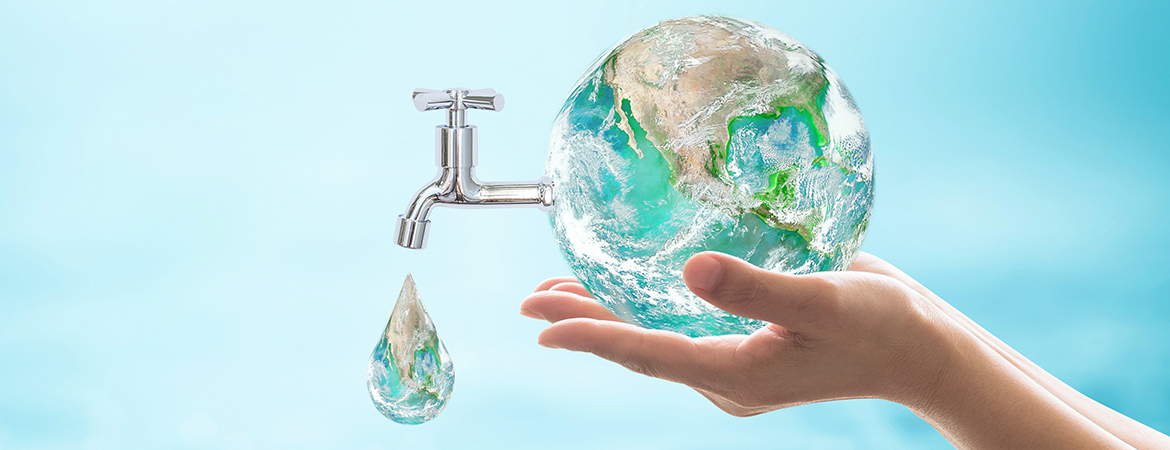 Hand holding earth with faucet dropping water