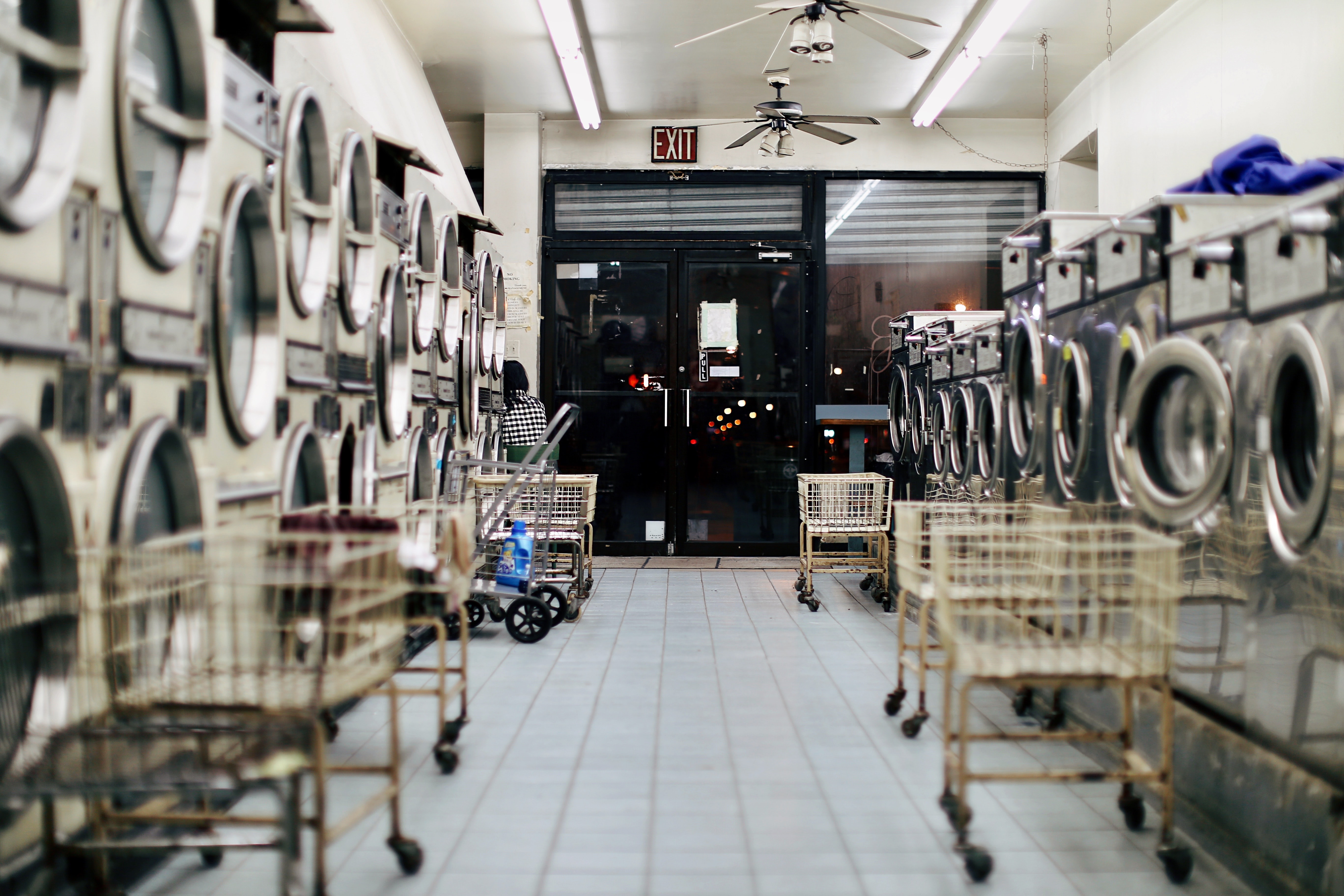 Well-lit laundromat with carts
