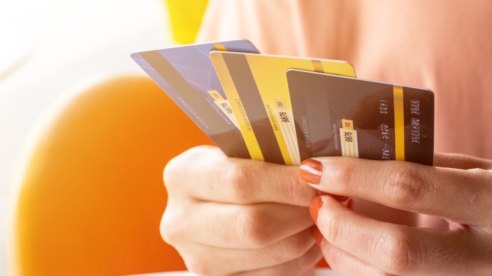 Woman hands holding three credit cards