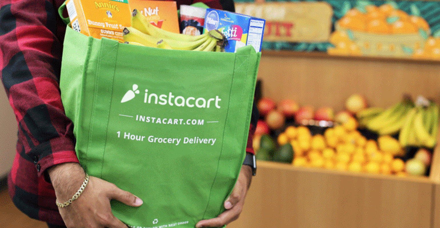 Person holding Instacart personal shopper bag