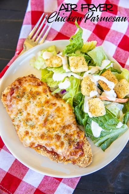 Air fryer chicken parmesan with salad on a plate