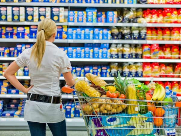 Woman shopping looking at eye level products at grocery store