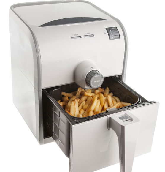 Overcrowded airfryer basket with fries