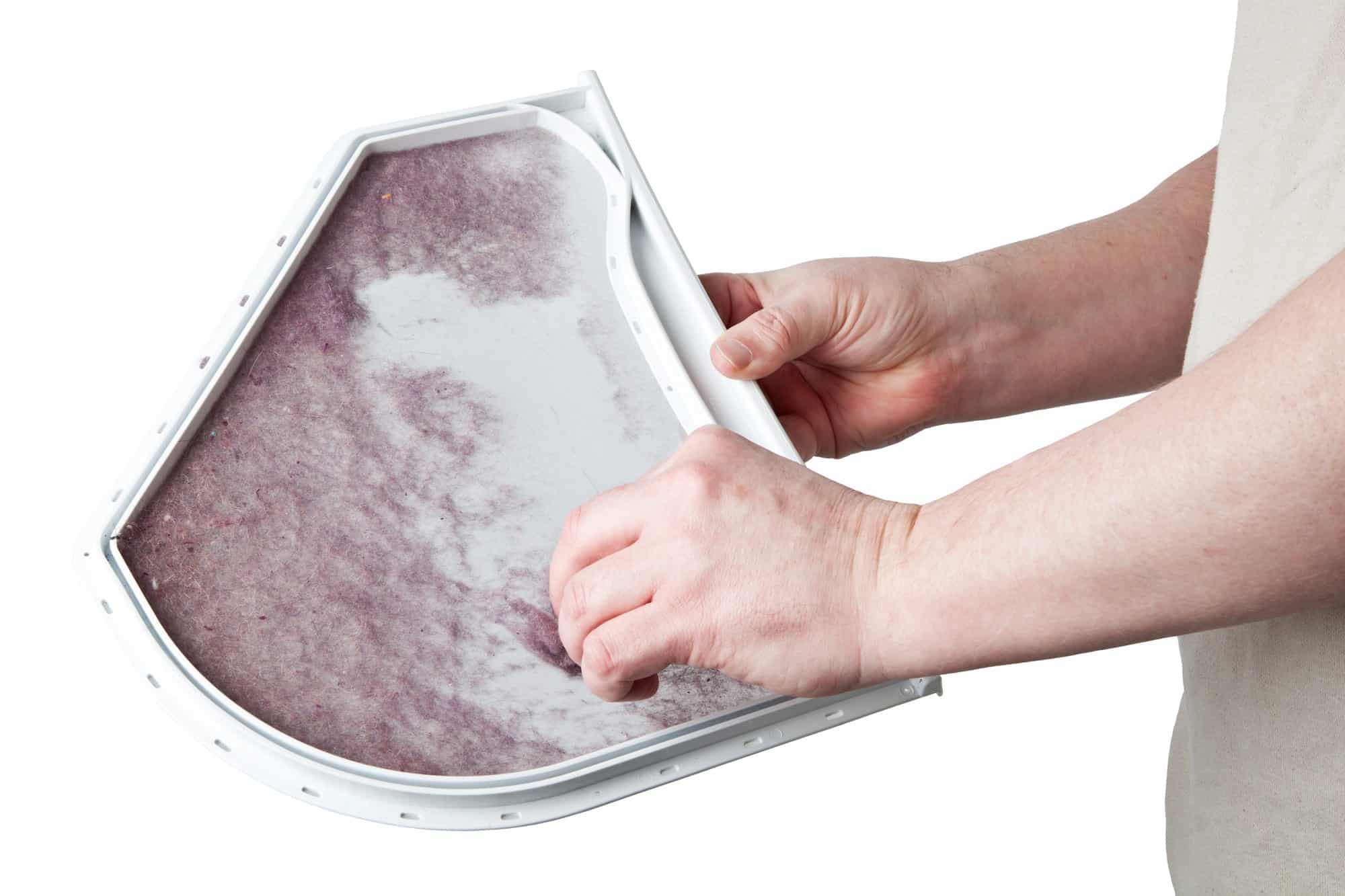 Person cleaning the lint from a dryers lint trap