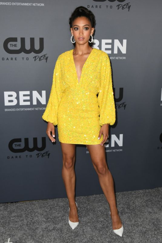 Samantha Logan wearing a glittery yellow dress at The CW renewal announcement event