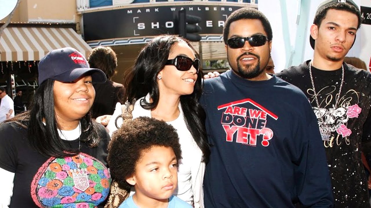Kimberly woodruff standing with her husband and children wearing a white shirt and black sunglasses