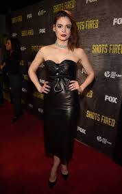 Conor Leslie wearing a black dress and black heels on a movie premiere.