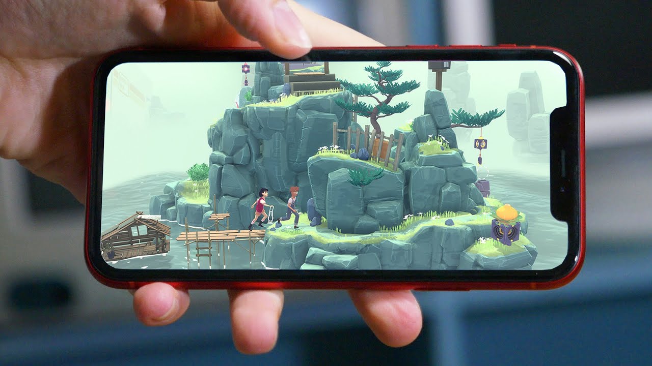 A man holding an iPhone while gaming