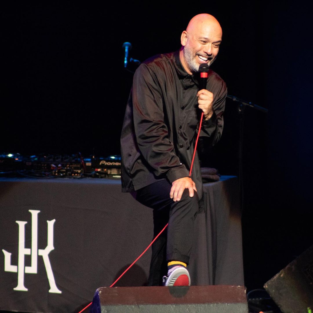 Jo Koy in black attire does stand-up comedy in Detroit, Michigan