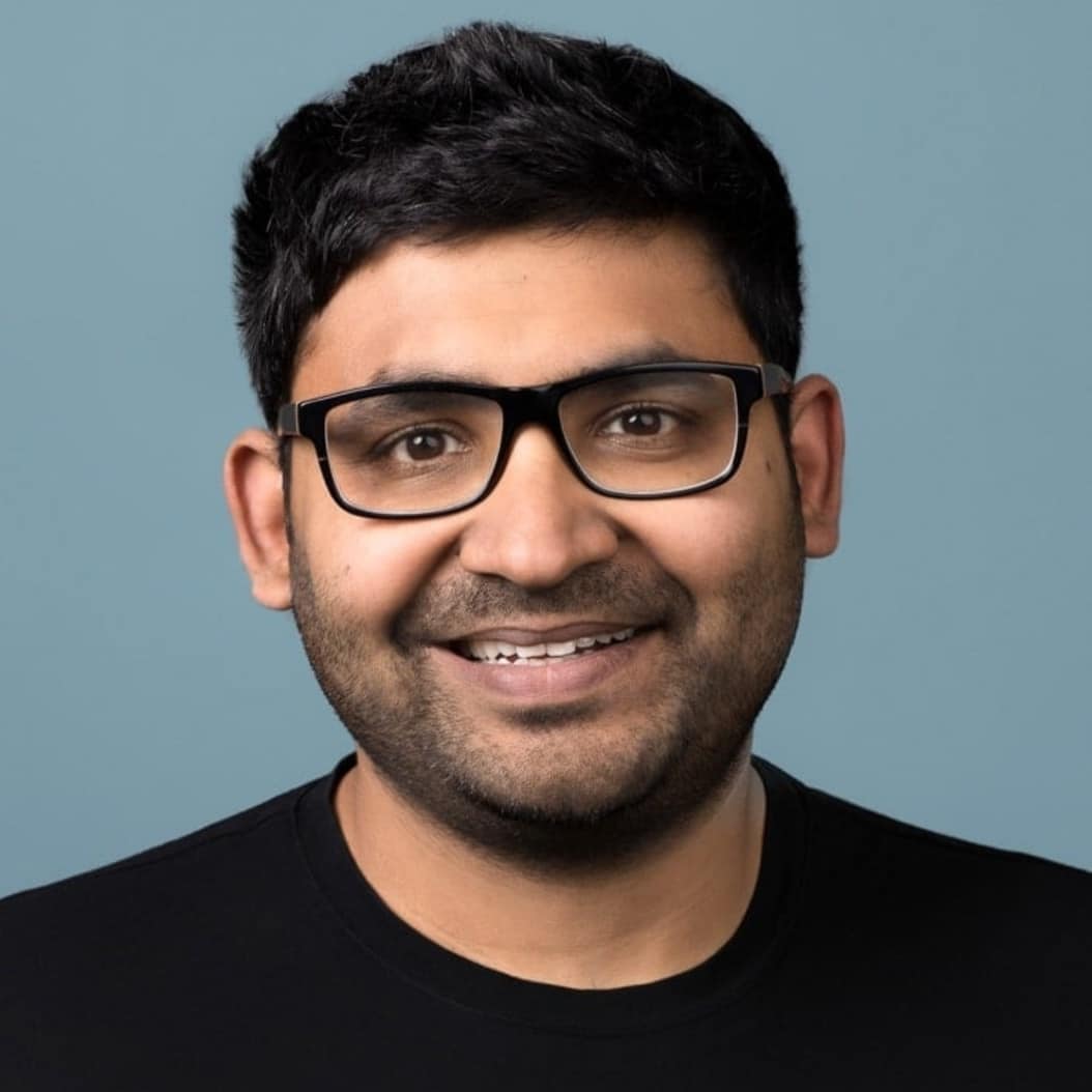 A smiling Parag Agrawal in black T-shirt and black-framed eye glasses