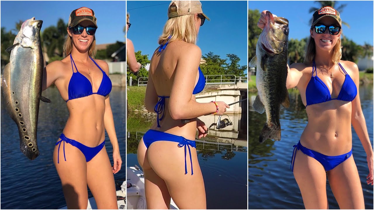 Vicky Stark wearing a blue two-piece bikini and holding a big fish