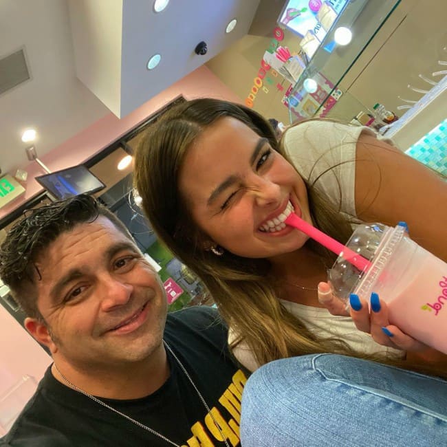 Monty Lopez with his daughter, Addison Rae, who drinks milkshake