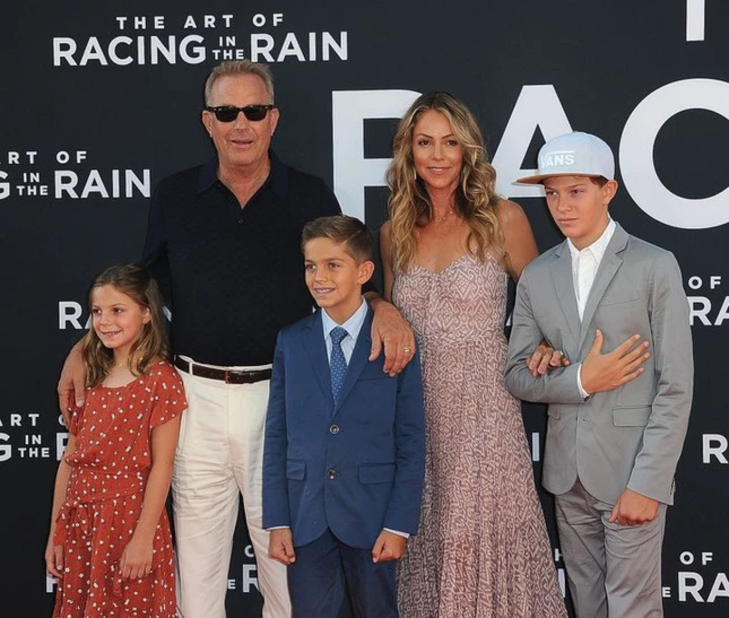 Christine Baumgartner and Kevin Costner with their three kids at the premiere of The Art in the Racing Rain