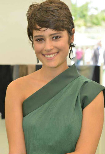 Rosabell laurenti sellers smiling and wearing a green dress