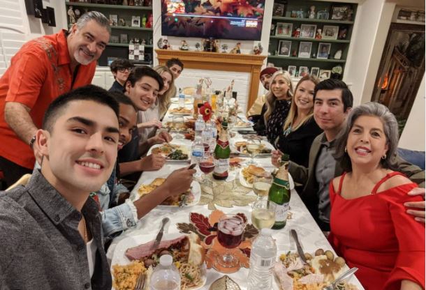 Diego Tinoco eating dinner with his family in a their home