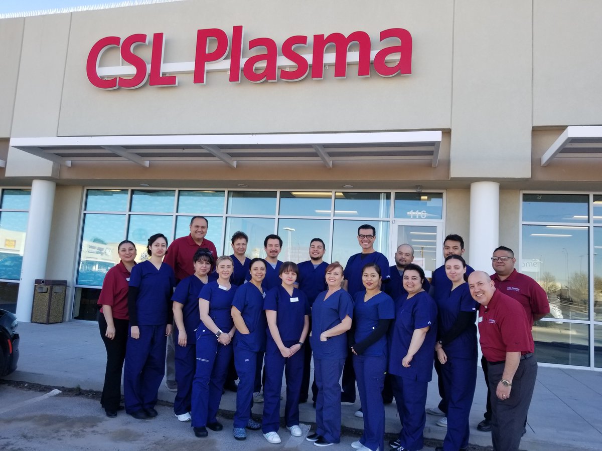 Male and female staff of CSL Plasma in their work uniform standing outside the office building in El Paso, Texas