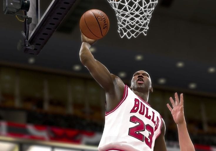 Michael Jordan in his white ‘Bulls 23’ jersey goes for a dunk in a Chicago Bulls game at the NBA