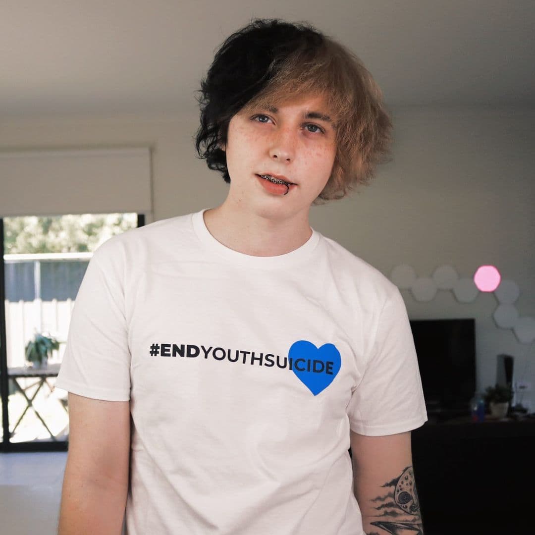 Caleb Finn wearing a #endyouthsuicide shirt, Caleb Finn black, and blonde hair color