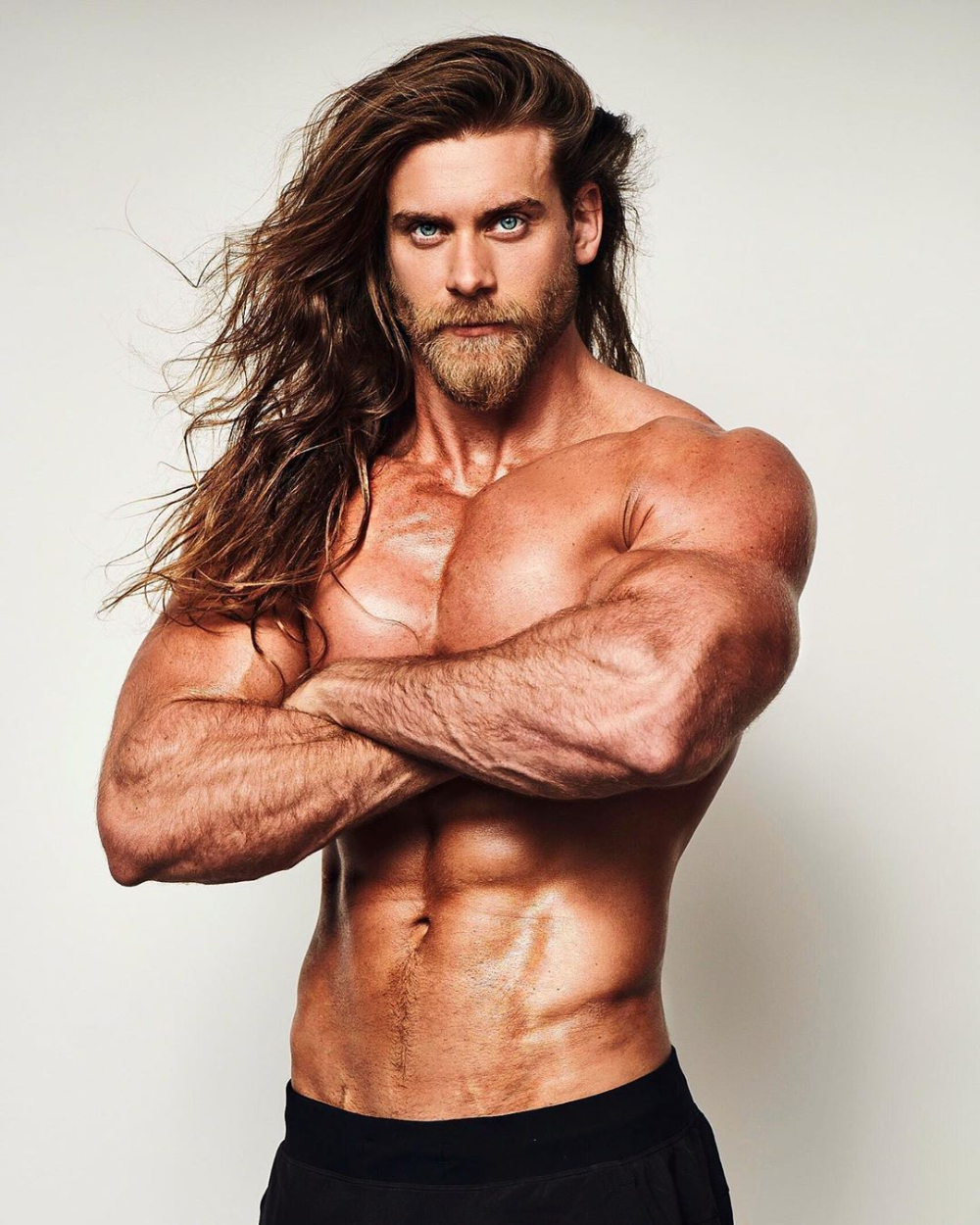 Brock O'Hurn posing and flexing his abs and muscles for a magazine
