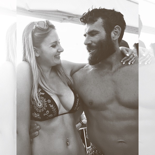 Black and white photo of claire abbott and dan bilzerian smiling at each other 