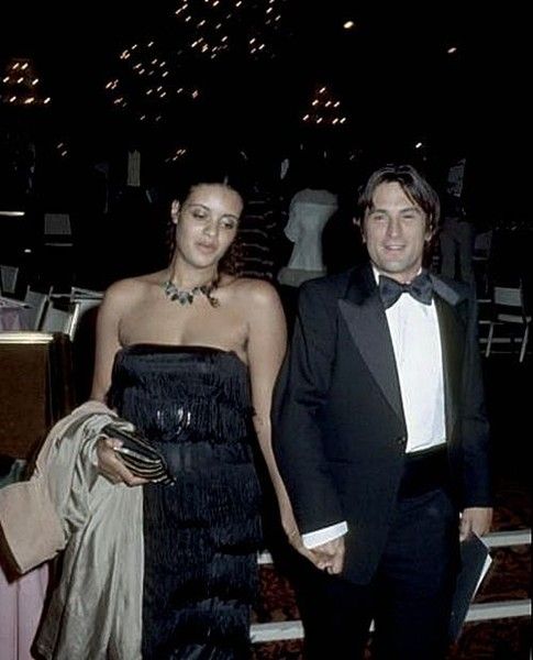 Robert De Niro And Diahnne Abbott wearing black and white formal attire in an event