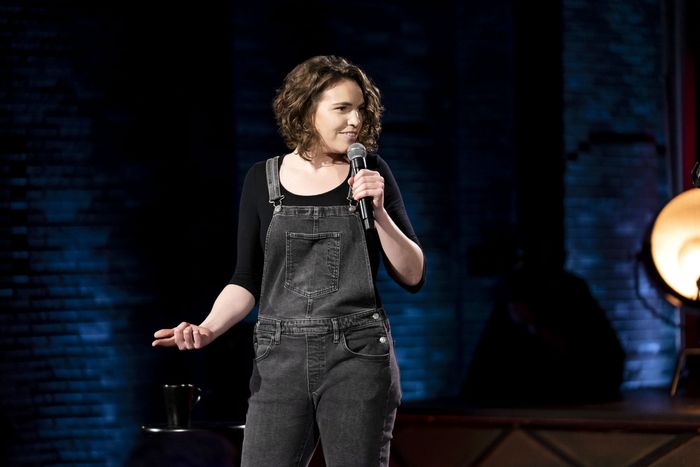 Beth Stelling performing on the stage of Girl Daddy wearing a jumpsuit