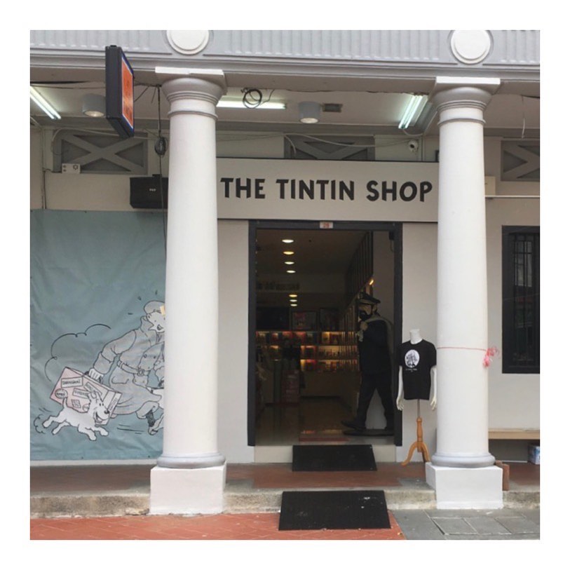 Façade of the Tintin Shop in Pagoda Street, Singapore, with two white columns at the entrance