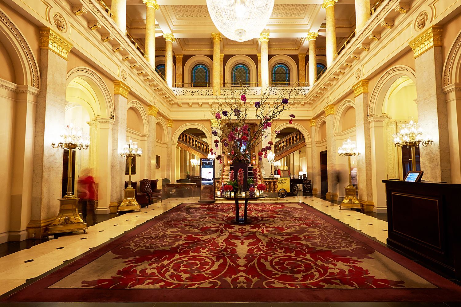 Lobby of The Clermont Victoria, with a huge white crystal chandelier hanging in the middle