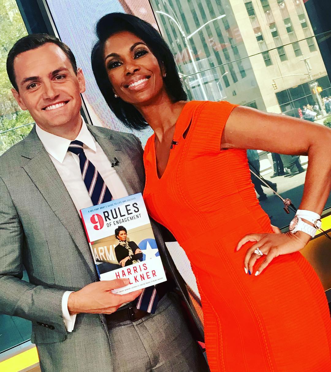 Mike Gallagher with Harris Faulkner holds Faulkner’s book, ‘9 Rules of Engagement’
