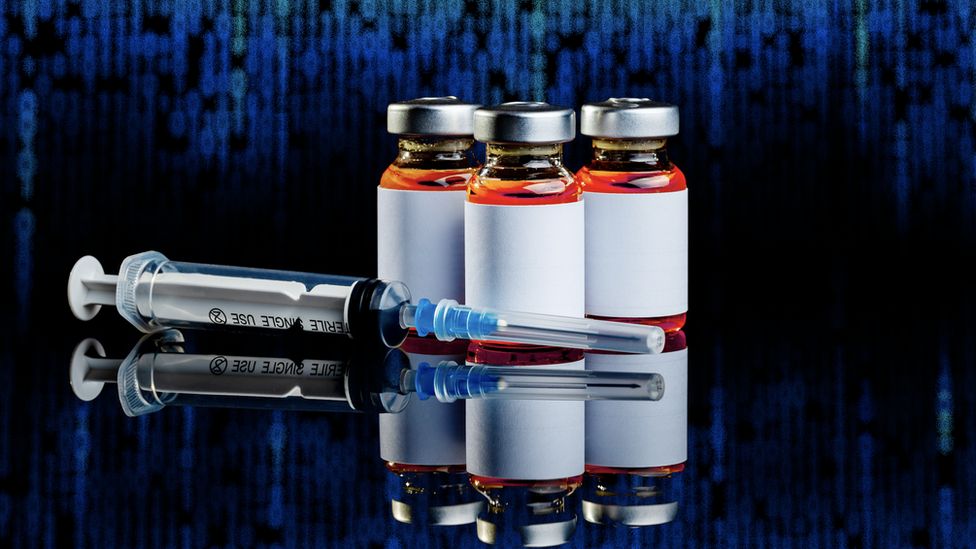 Three vaccine bottles with an injection syringe