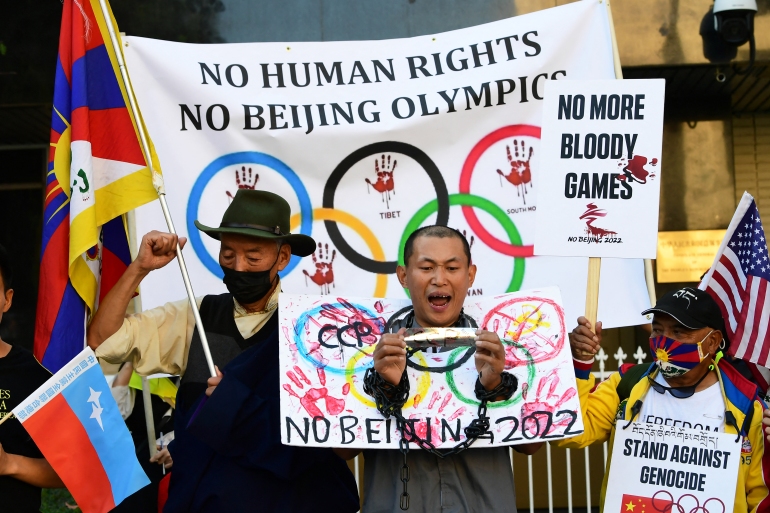 Olympics Activists shouting with handcuffs along with banners