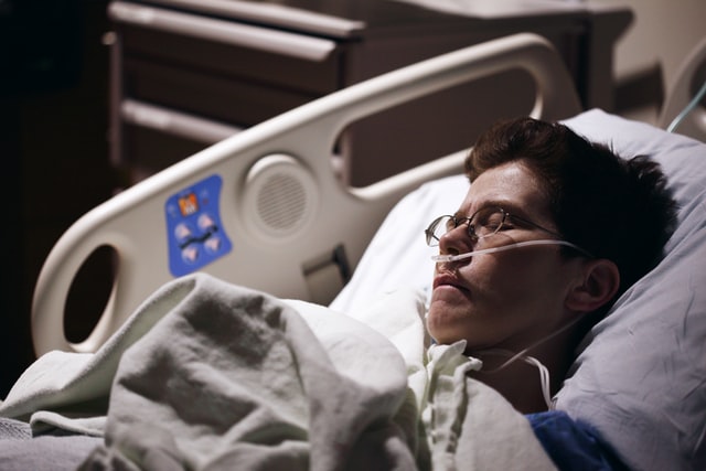 Bespectacled hospital patient with nasal cannula falls asleep after receiving medical marijuana