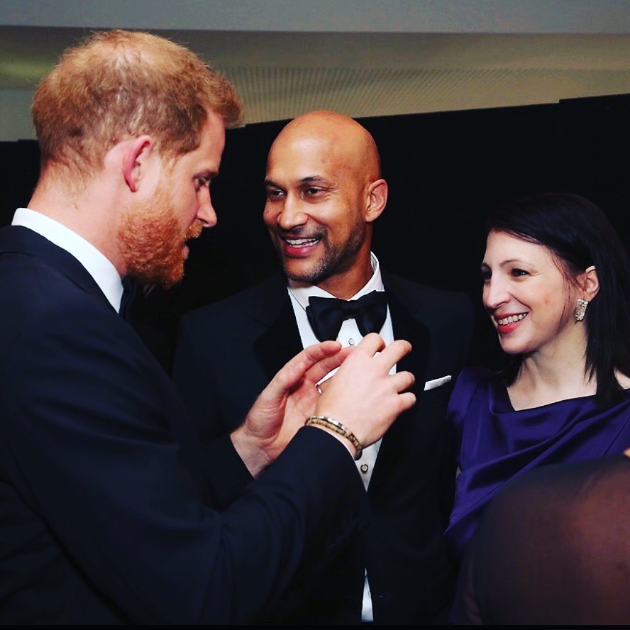 Prince Harry gestures as he talks to Keegan-Michael Key and Elisa Pugliese in London