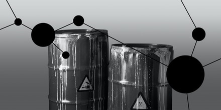 Black and white pic grey colored steel drums with danger signs
