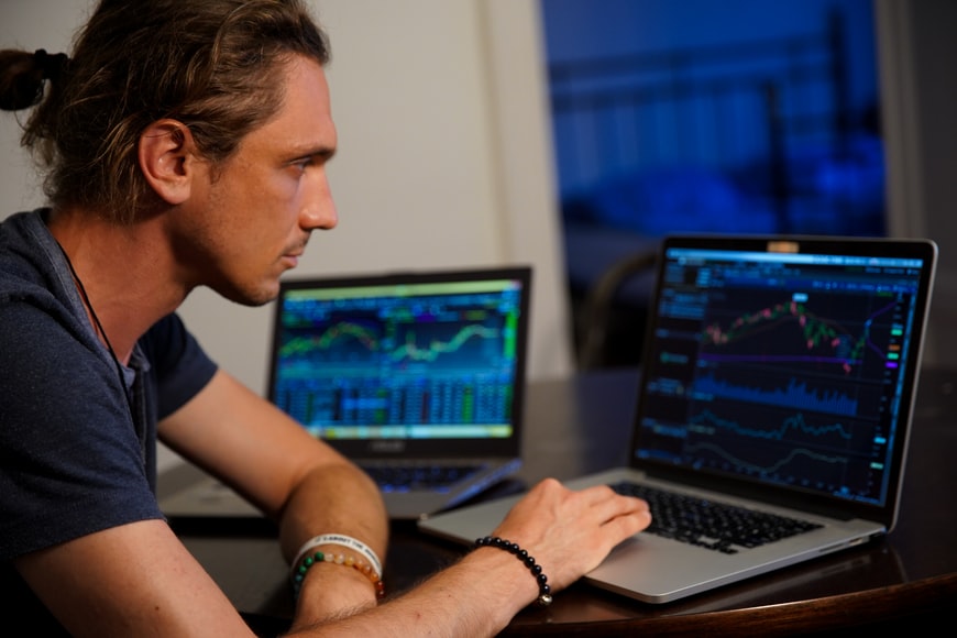 A person browsing on his laptop with day trading charts
