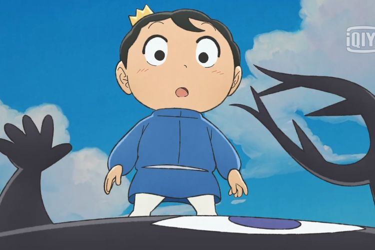 A little boy wearing a crown and blue long sleeve clothes standing on a enormous black creature