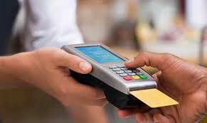 Hands handing a card payment device
