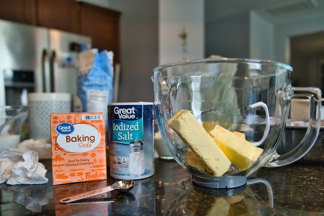 Great Value baking soda and iodized salt and chunks of butter in a wide glass jug