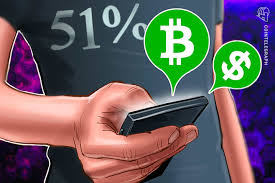 Someone in a black shirt with a 51 percent on his shirt holding a smartphone with dollar and bitcoin bubble on top of the phone