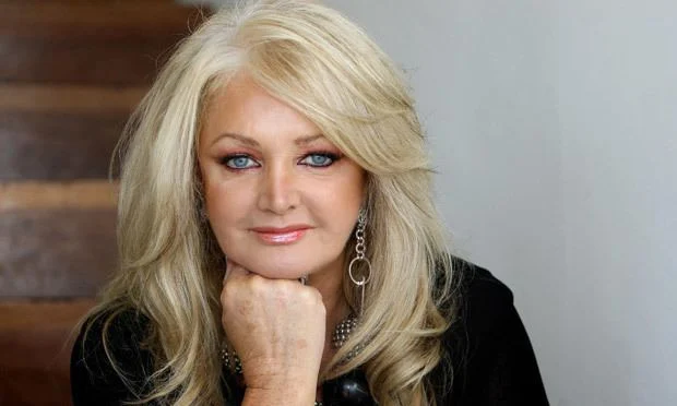 Bonnie Tyler looks as beautiful as she is a pure example of beauty in her black top blonde hair and blue eyes