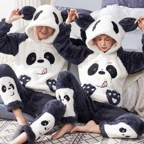 A couple wearing a panda Pajamas Set while sitting on the floor at the end of the bed