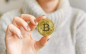 A woman holding a bitcoin