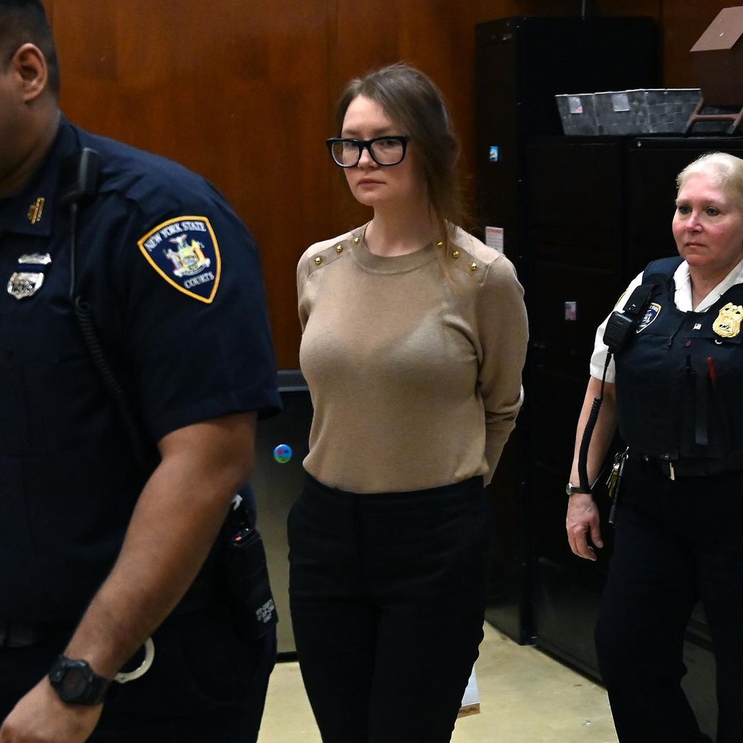 Anna Sorokin walks in a New York courtroom while handcuffed behind her back