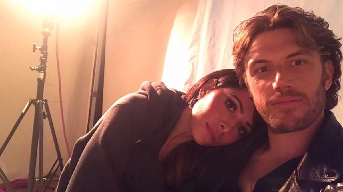Selfies of adam demos and sarah shahi on the set wearing black clothes