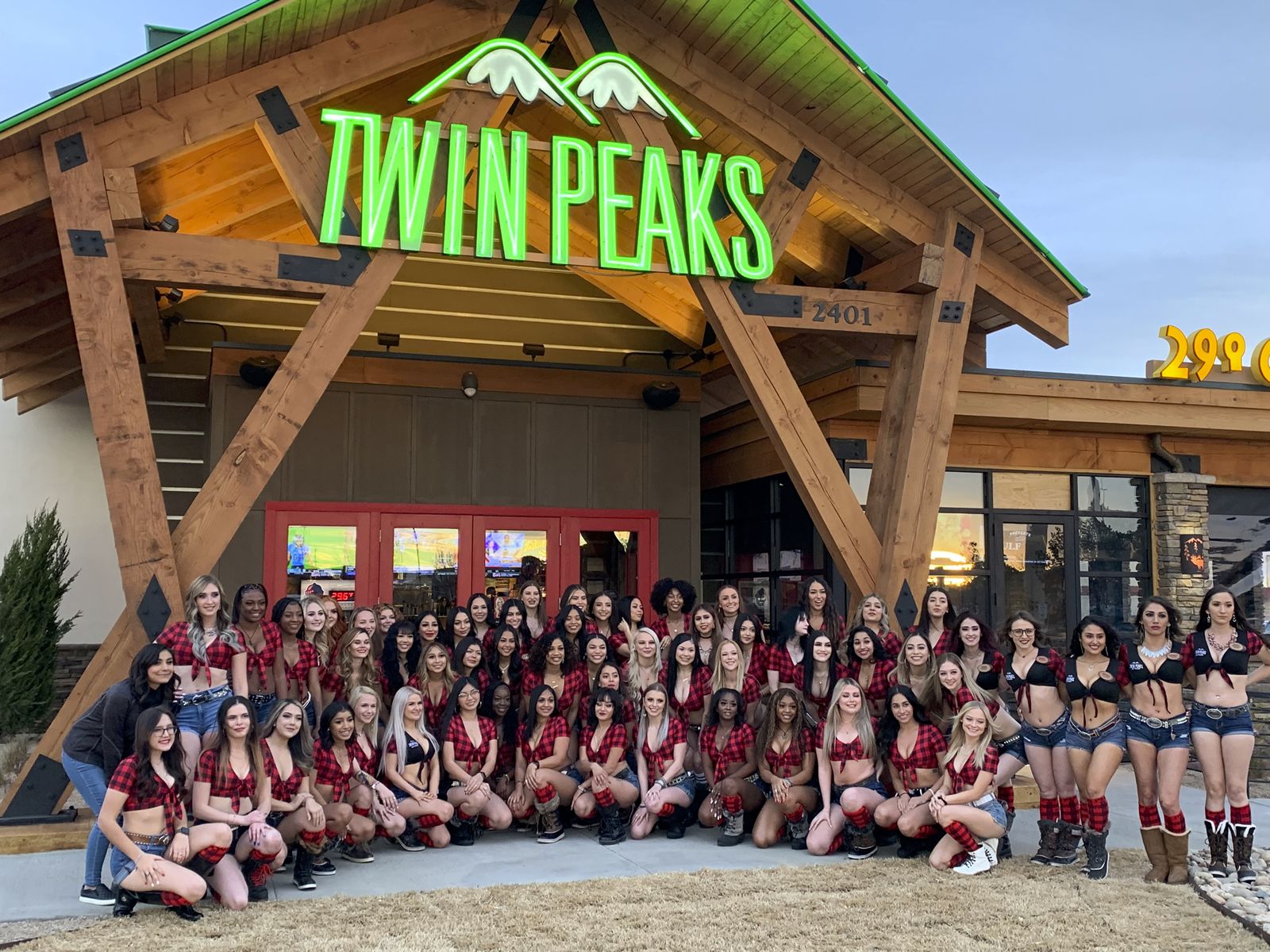 Twin Peaks Restaurant And Twin Peaks Girls in front of it smiling