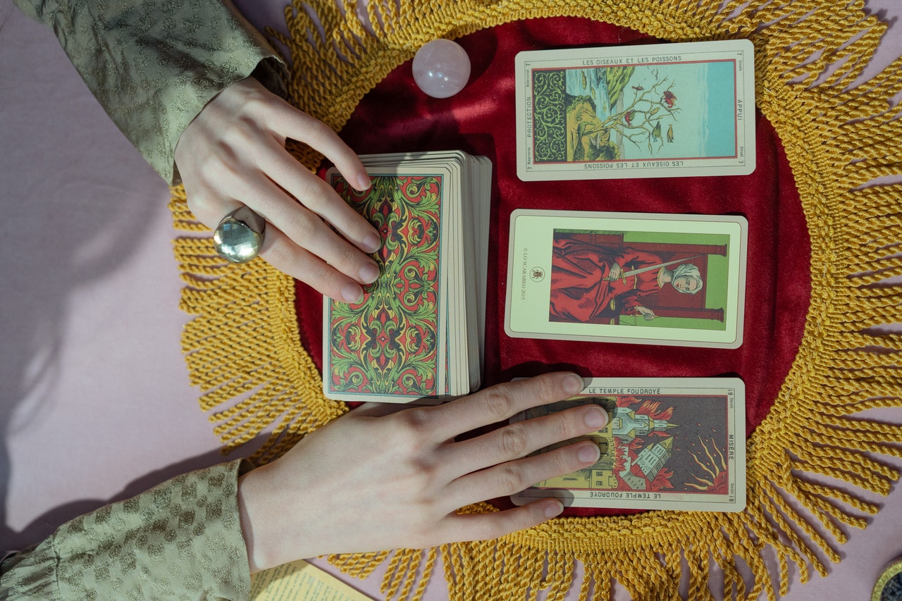 A Person Holding Tarot Cards