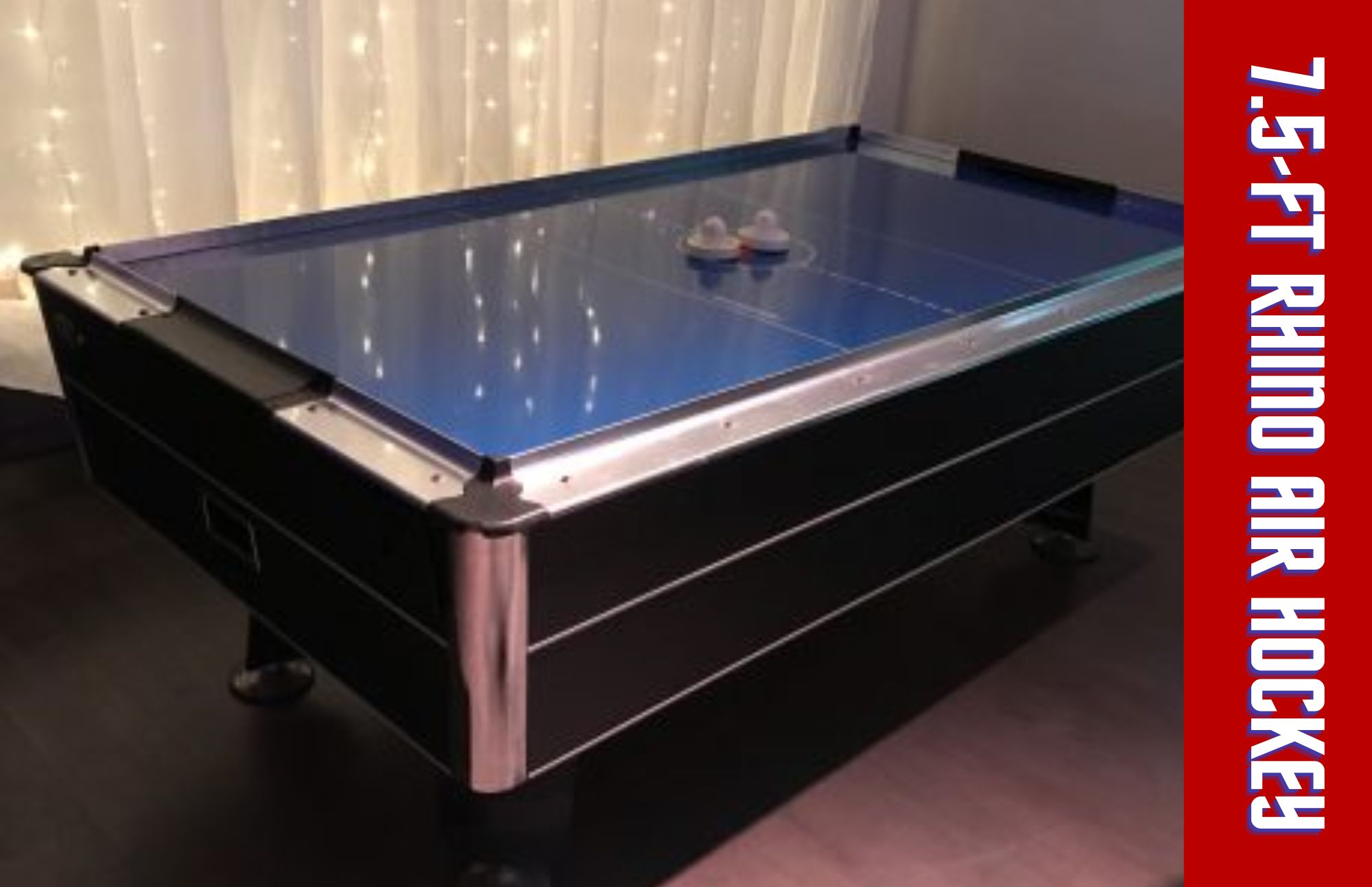 The 7.5-ft rhino air hockey table has a blue glossy table surface and a pair of white pushers
