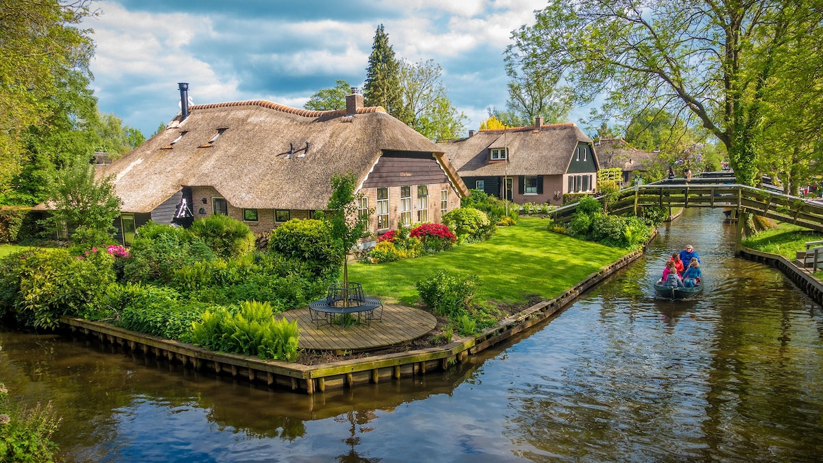 Some people riding a boat in Giethoorn, the Netherlands