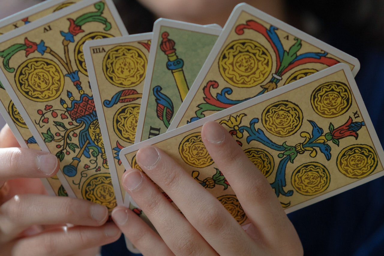 Person Holding Tarot Cards