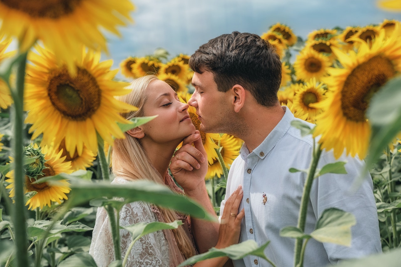 Loving couple embracing in the sunflower field